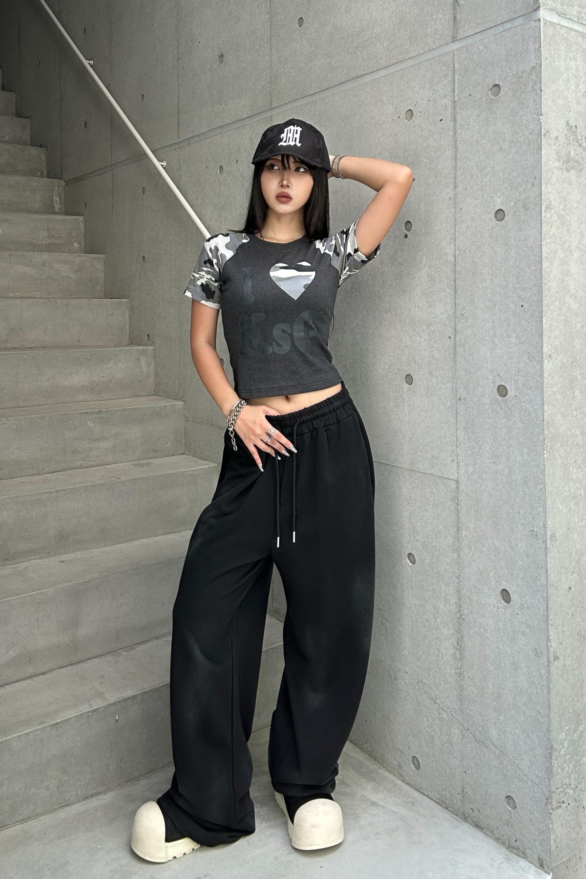 Y2K fashion asian model in tummy shirt, hat, and saggy pants