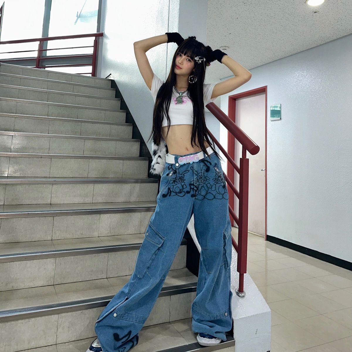 Dark haired asian model in crop top, and spray painted saggy pants