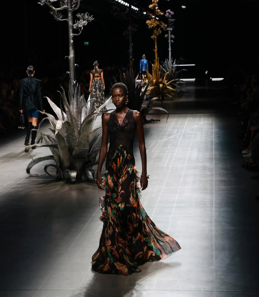 Awar Odhiang walks the runway at the Etro Spring 2025 ready-to-wear collection fashion show, wearing a boho-style long dress