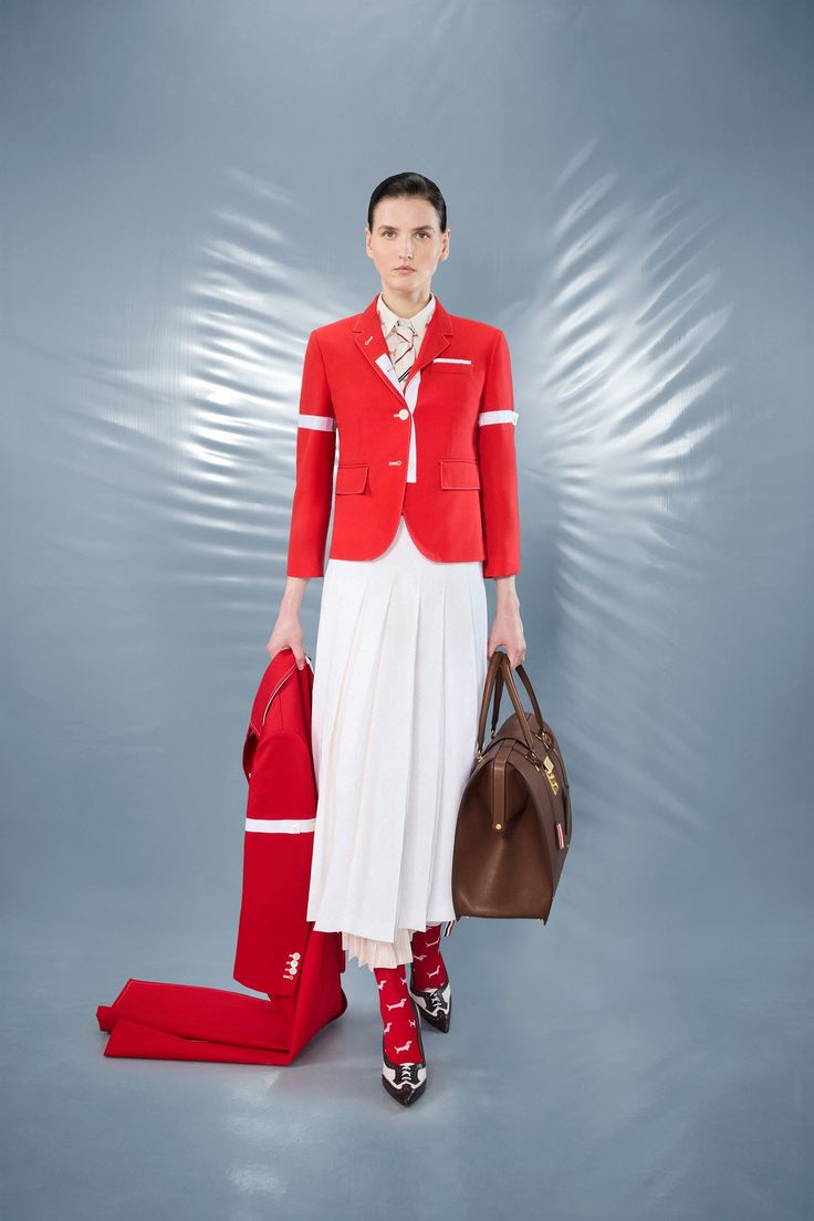 The Thom Browne Resort 2025 collection included a crimson red coat, a white pleated skirt, and socks with a dog design.
