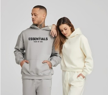 male and female models each wearing an Essentials tracksuit