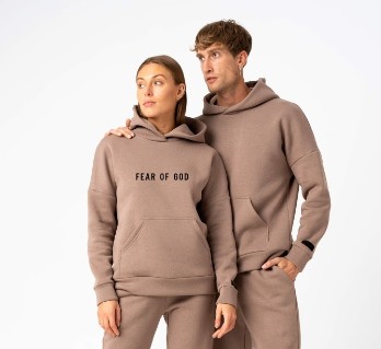 two models wearing Essentials tracksuits