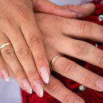hands wearing wedding bands