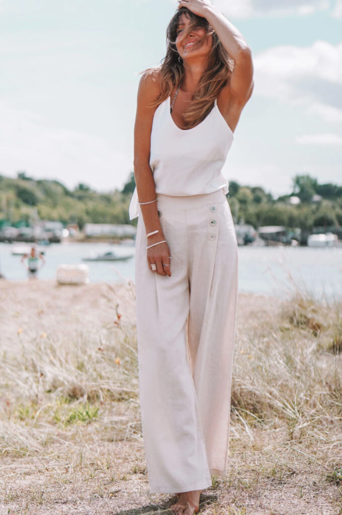 woman in white sleeveless top and button up pants