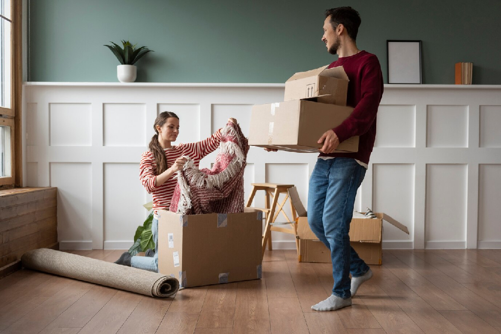 Couple packing boxes for a move