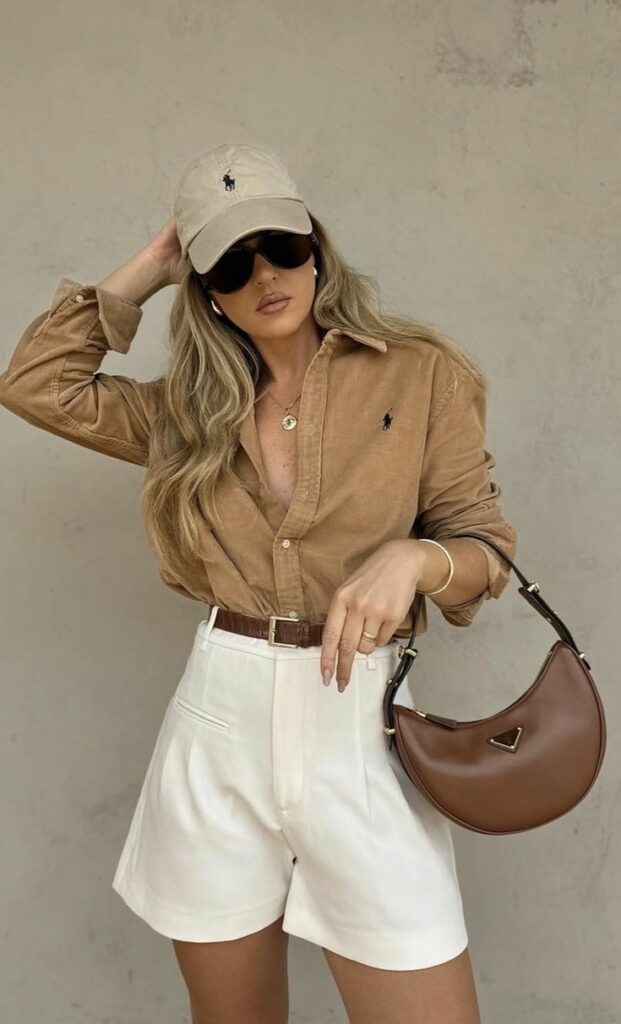 Model wearing Polo hate and shirt with white shorts