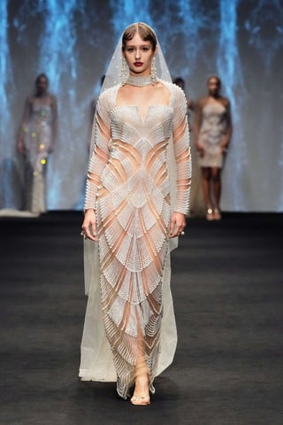 Model wearing white semi transparent dress 