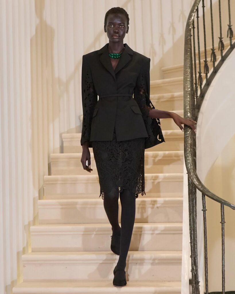 Achol Ayor walks down the runway wearing a monochromatic two-piece lace guipure blazer and lace skirt during the Oscar de la Renta Fall/Winter 2025 ready-to-wear collection.
