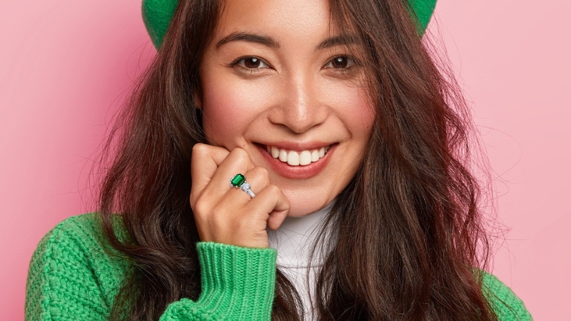 Woman wearing emerald stone ring