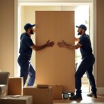 Two men moving big box for a house removal company