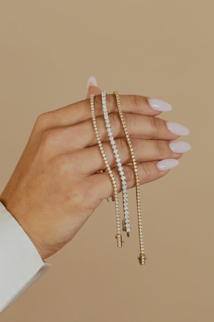hand holding 3 Tennis Bracelets