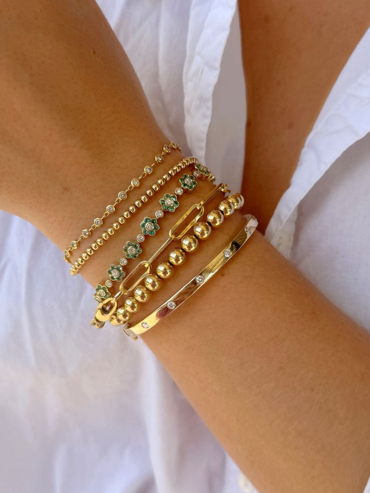 wrist wearing 5 various tennis bracelets