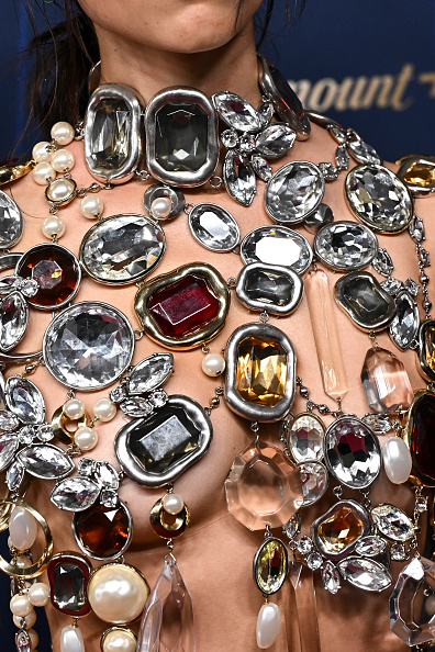 Jenna Ortega of Netflix’s “Wednesday” donned a Givenchy shattered chandelier jewelry top that gently hung over her tummy and featured pearls, diamonds, crystals, and resin drips.