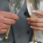 two hands toasting with drinks