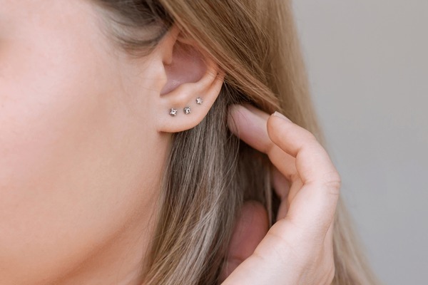 Girls ear with diamond stud earrings