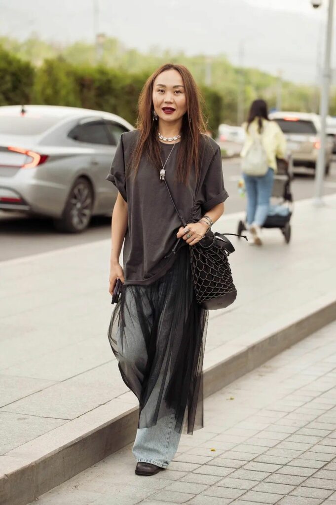 wo0man wearing sheer skirt over jeans