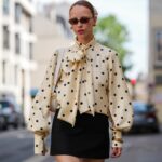 girl wearing beige and blue vintage prep and polka dots