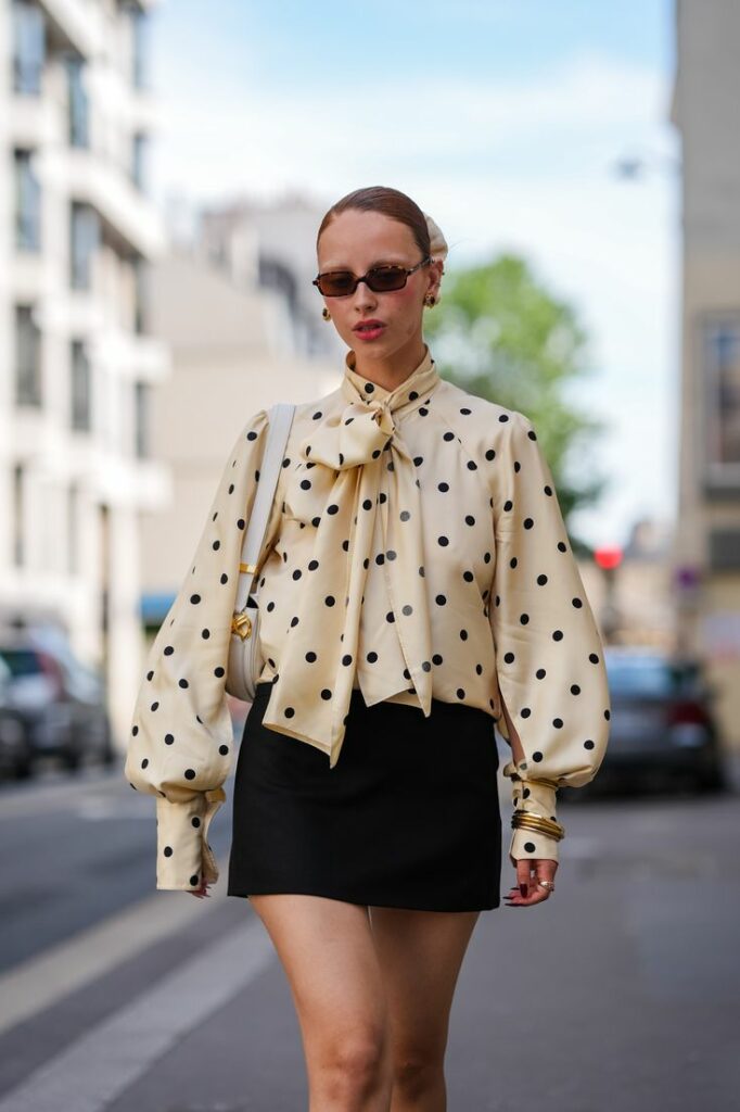 girl wearing beige and blue vintage prep and polka dots