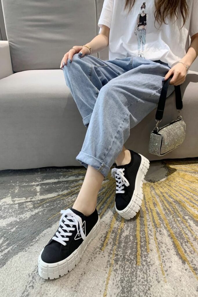 Girl in jeans wearing Prada sneakers for women