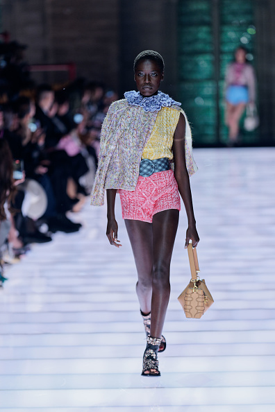 Awar Odhiang walks the runway during the Louis Vuitton Cruise 2026 collection in a cardigan and belted hot pants set.