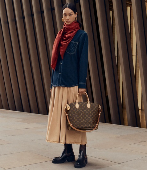 woman holding Louis Vuitton bags