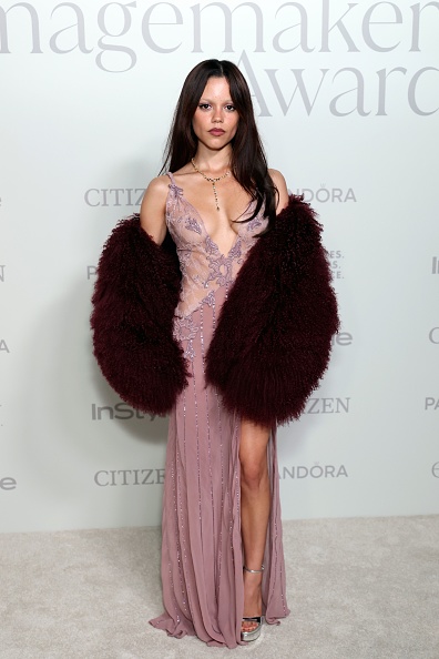 Jenna Ortega attended the 2025 InStyle Imagemaker Awards dressed in an Amiri puffy jacket and a daring lace leg-slit dress.