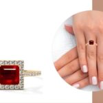 wom ans hand wearing natural ruby ring
