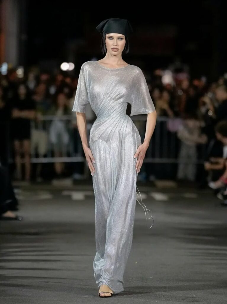 Siri Lehland walks the runway at New York Fashion Week in a crystal twisted-waist gown from Christian Cowan’s Spring/Summer 2026 collection.