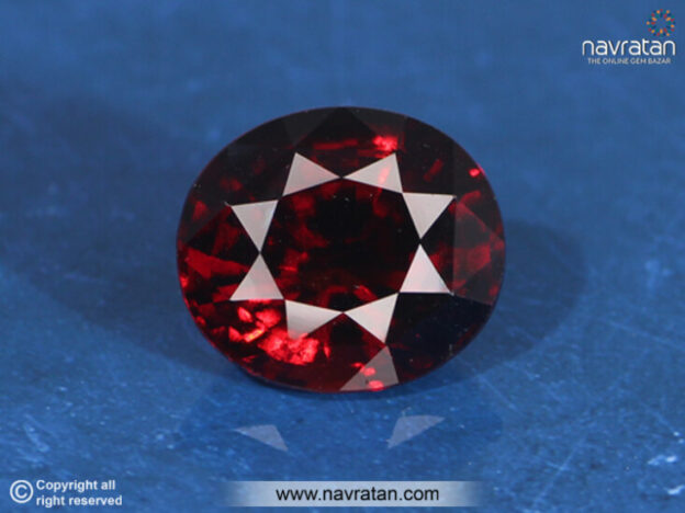 Hessonite stone on blue background