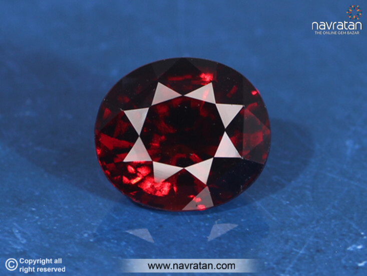 Hessonite stone on blue background