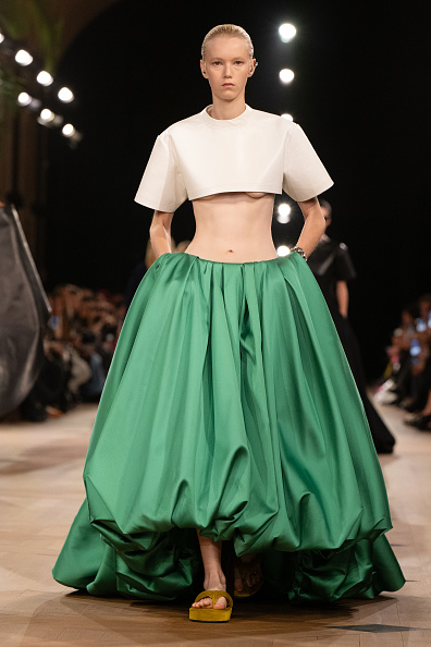 The Balenciaga Women’s Spring/Summer 2026 ready-to-wear fashion show titled “The Heartbeat” featured a white cropped top and a green pleated bubble skirt.