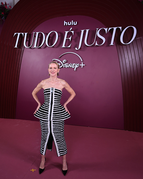 Naomi Watts dons a Balmain Fall 2025 strapless midi dress with black and white stripes and a peplum design at the ‘All’s Fair’ Rio Premiere Red Carpet Event.