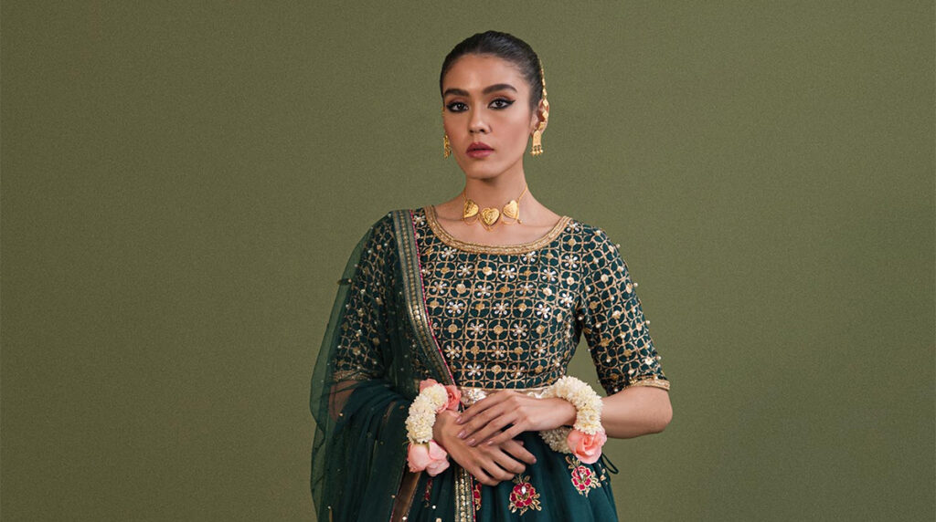 pakistani fashion shopping model on green backgrounbd wearing traditional pakistani outfit