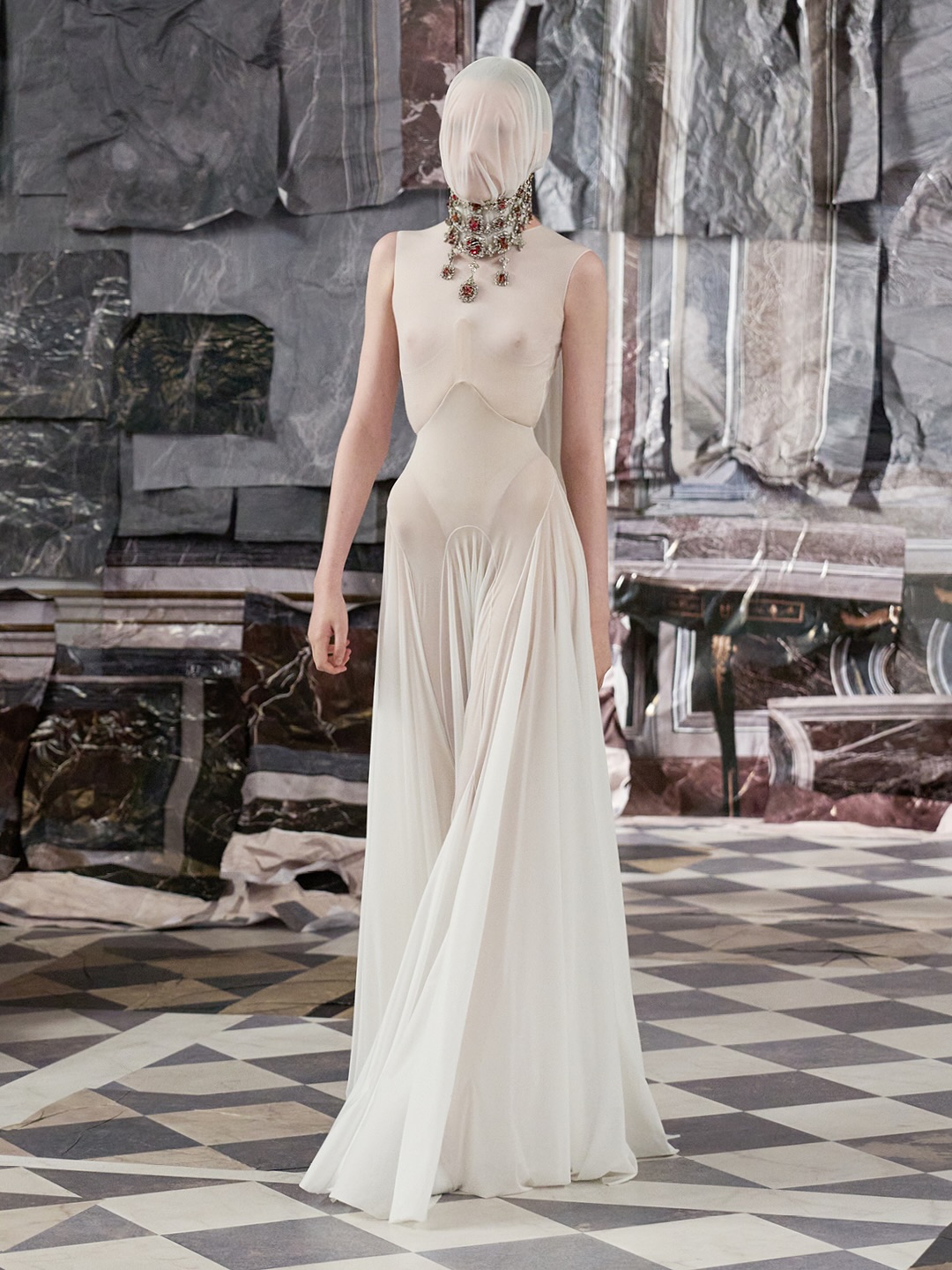 Ivy Stewart, a fashion model, walks down the runway at Maison Margiela Artisanal Fall/Winter 2025 Haute Couture in a transparent jersey costume