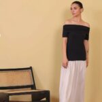 women's western wear in Pakistan model in black off the shoulder top and white midi skirt