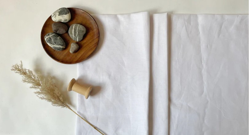5 stones in a plate with spool and stalk to show how hemp fabric is becoming a popular substainable fabrics 