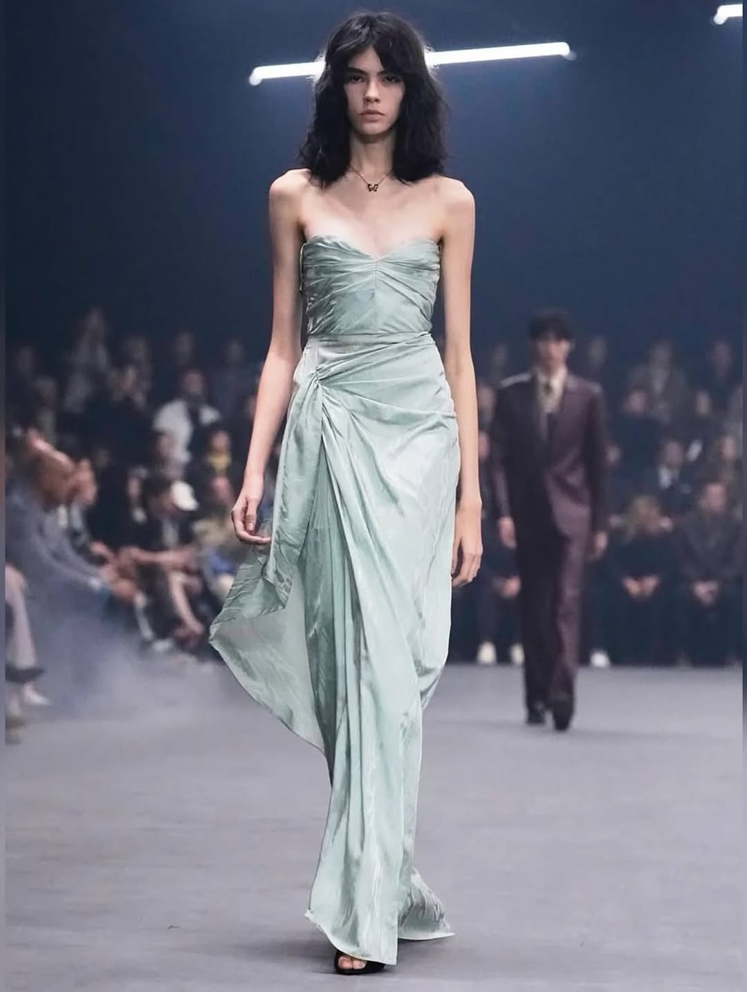 Model Isa Chagas strides down the runway for the Maison Valentino “Fireflies” Spring/Summer 2026 collection, adorned in a strapless silk satin draped gown