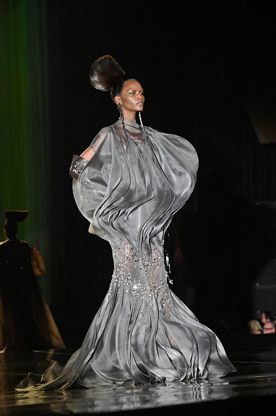 A fashion model strides confidently down the runway at the Stéphane Rolland Haute Couture Spring/Summer 2025 show,