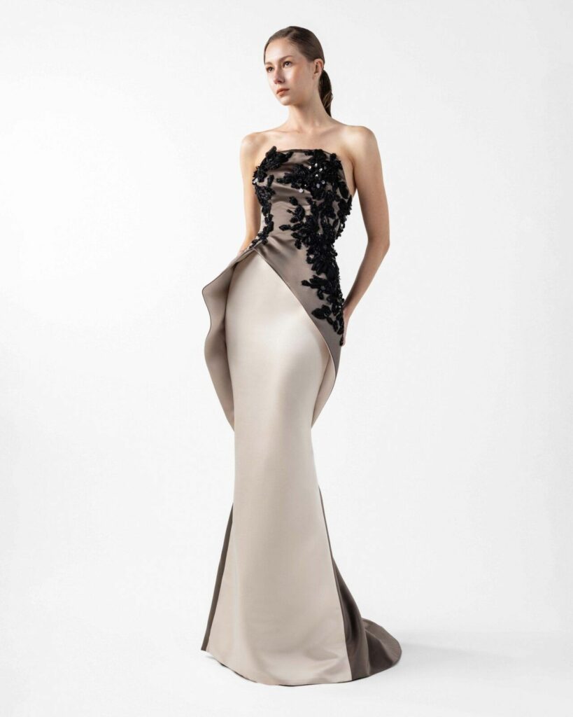The dress features a strapless, straight neckline beads, sequins, and fabric petals