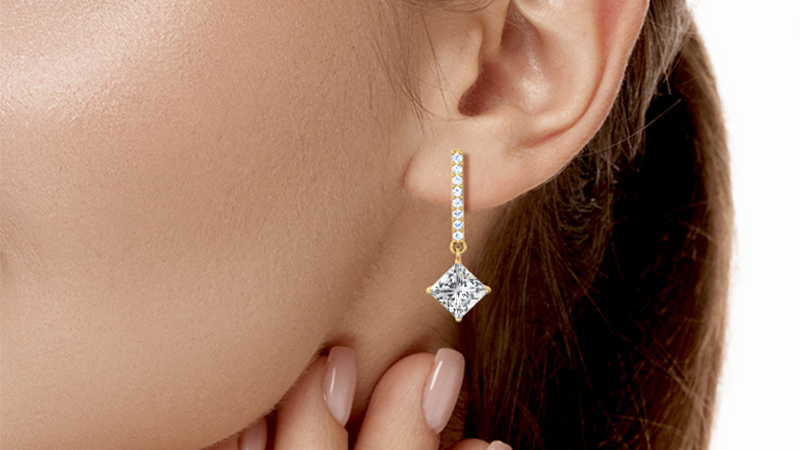 woman wearing diamond earrings danglers