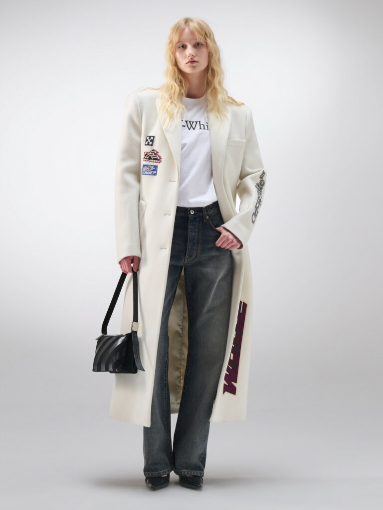 Model wearing Off white full length jacket with white graphic T shirt and jeans