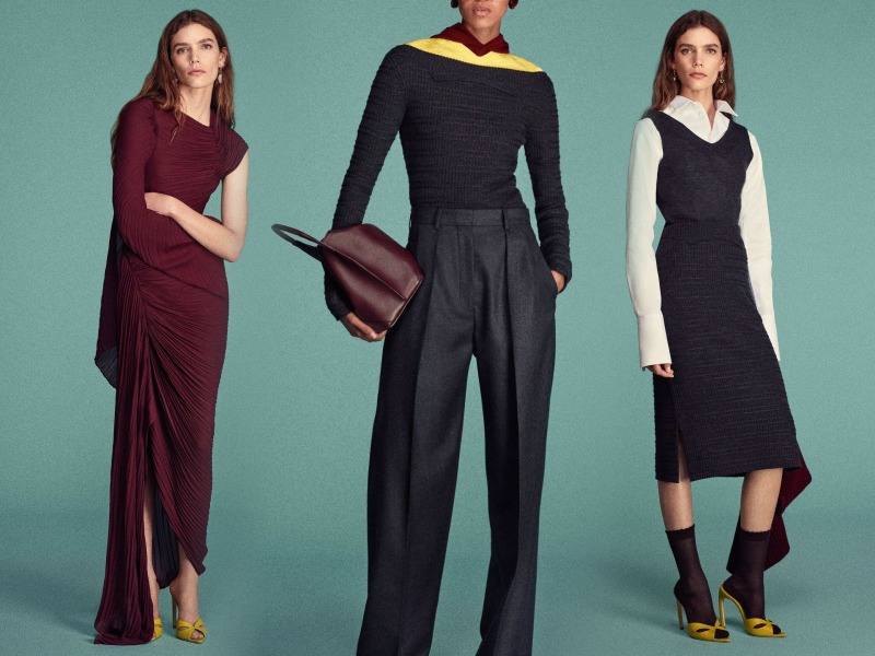 Two female and one male model wearing a maroon wrap over the shoulder dress, a balck skirt with sweater vest and pleatedf pants and long sleeve shirt with yellow accent 