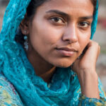 Pakistani girl wearing sensitive earrings with blue dress